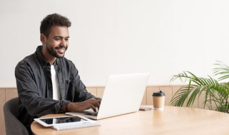 Man Working on Computer Smiling