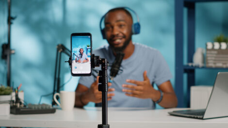 Man filming video with smartphone on tripod