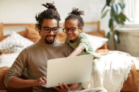 Father working on his computer with his son