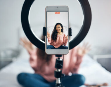 Woman smiling at the phone while she live streams