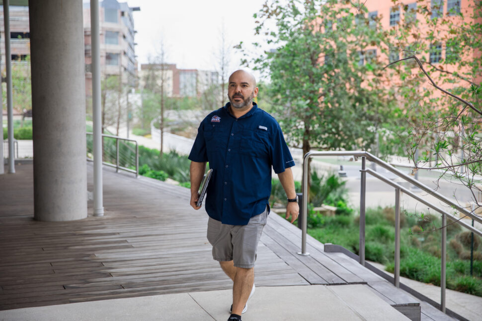 UT San Antonio Online student walking with laptop