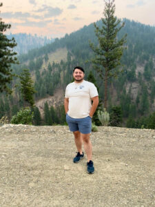 Mario Ortega standing with Washington mountains behind him