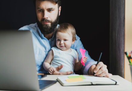 Parent with child taking an online course in his laptop. 