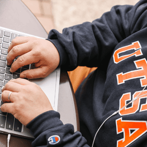 utsa student writing on laptop