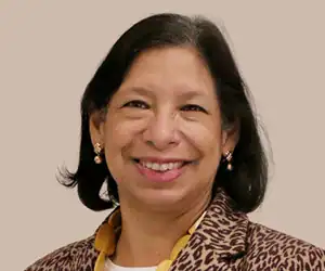 Woman with chin-length black hair and a brown top.