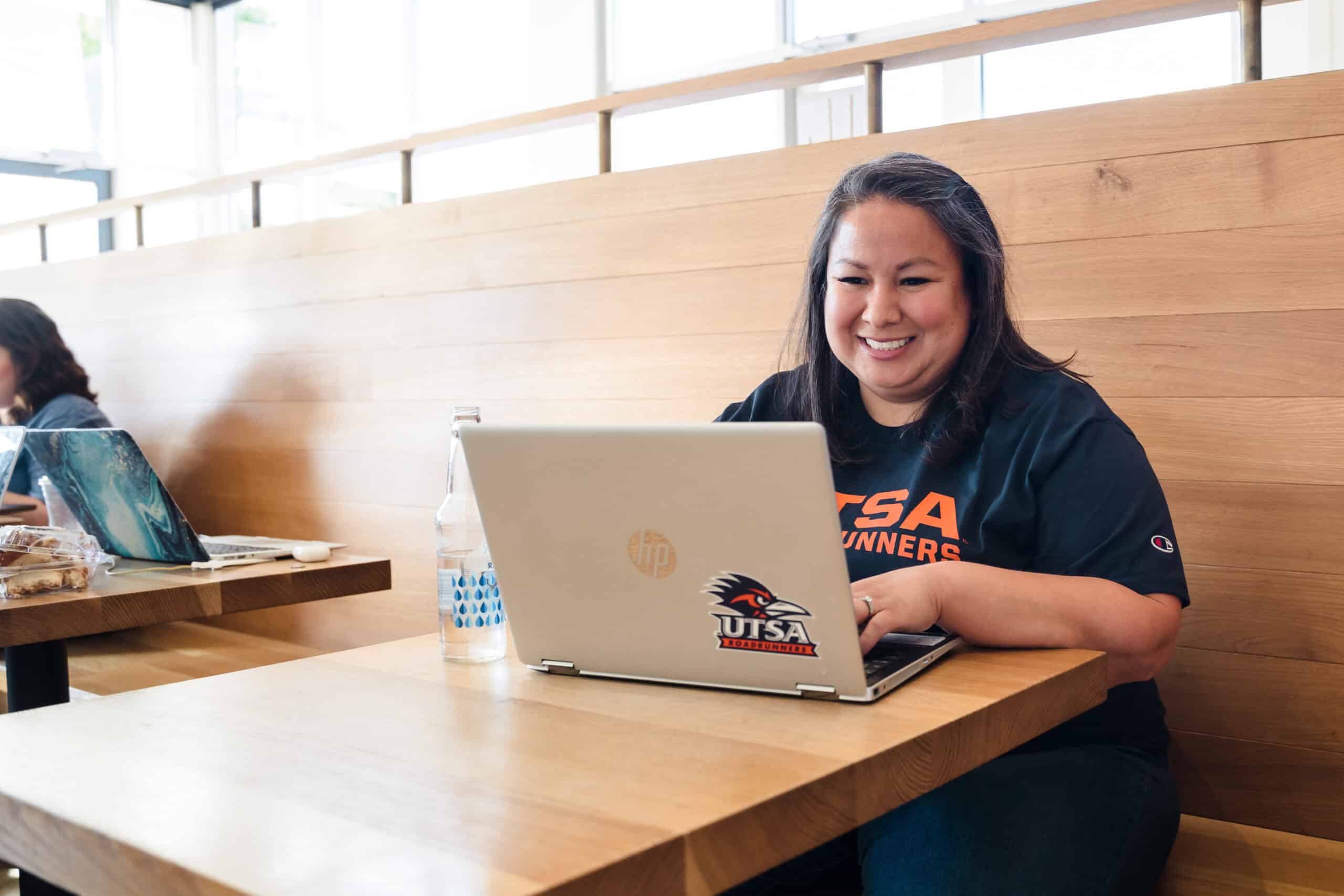 female online student working in her laptop