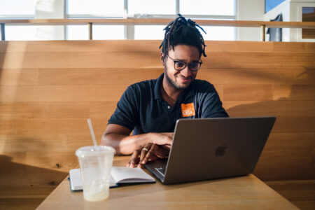 Man working on laptop in coffee shop