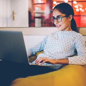 female student sitting in a bean bag with laptop