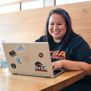 female online student working in her laptop